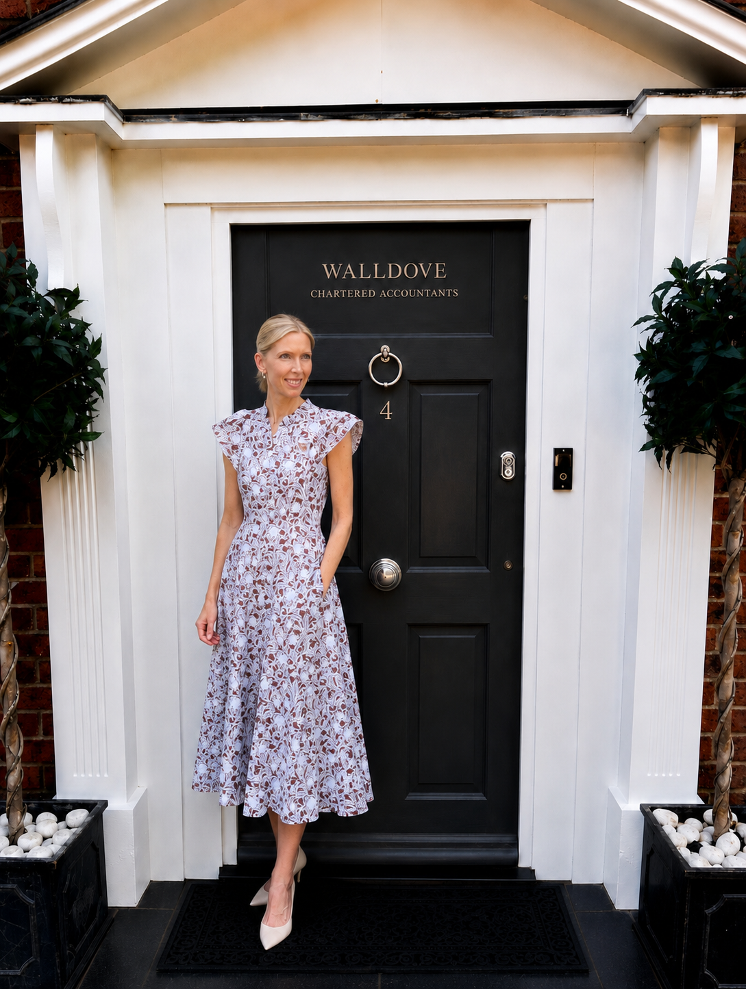 Clare Wallhead standing outside the Walldove Chartered Accountants entrance